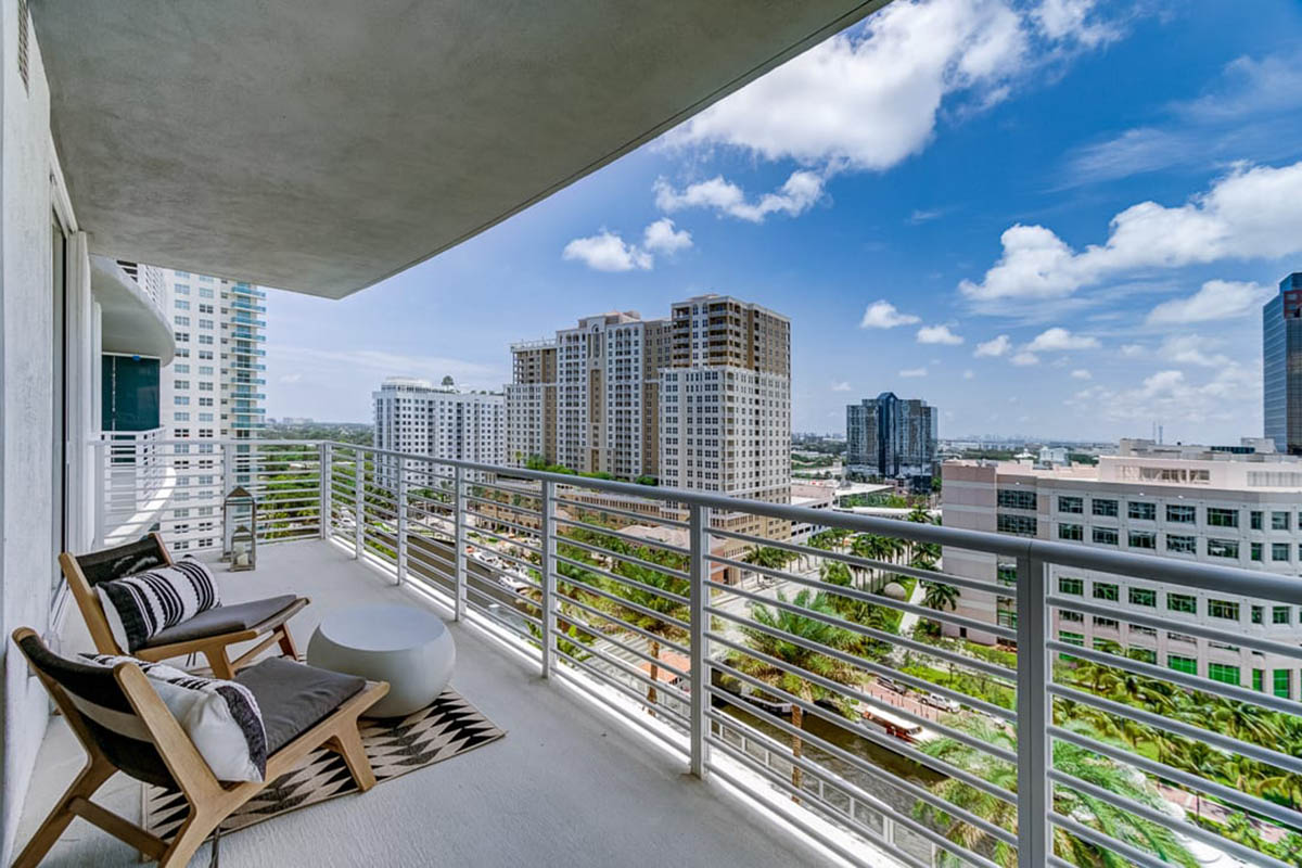 Apartment balcony with lounge chairs overlooking Fort Lauderdale.