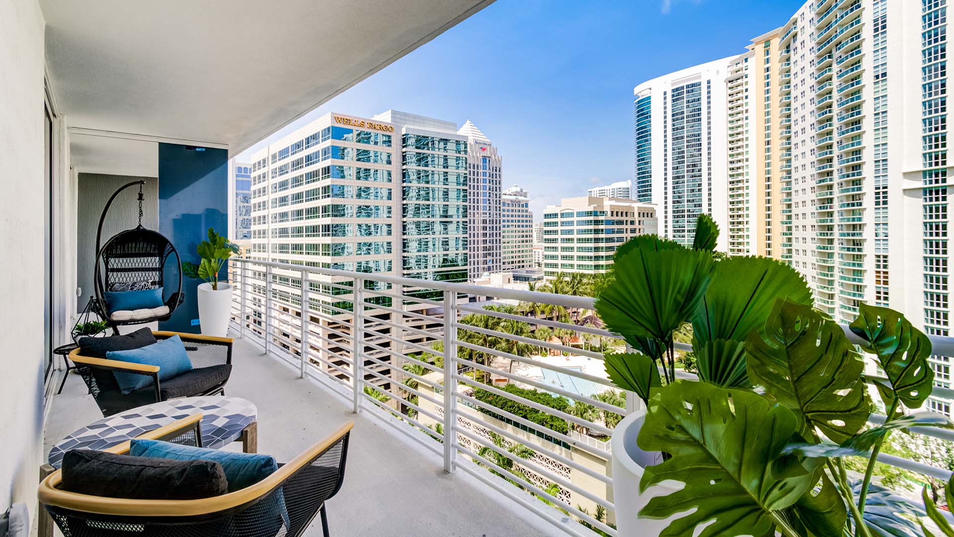 Balcony with comfortable seating and plants overlooking East Fort Lauderdale.